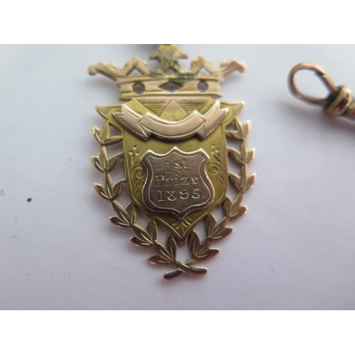 135 - A 9ct yellow gold watch chain with a 9ct medallion fob - Length 34cm - approx weight 35 grams - each... 