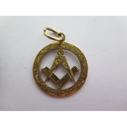 137 - An 18ct yellow gold Masonic fob - Width 22mm - approx weight 4 grams - and a silver masonic Fulcrum ... 