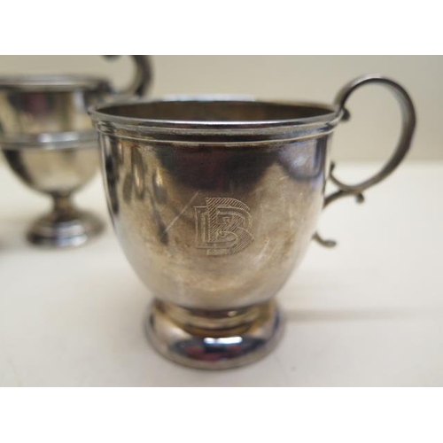 232 - A pair of silver salts, a silver pepper, silver cup, small silver tankard - engraved, two spoons, a ... 