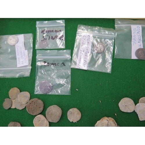 314 - Five Roman coins, assorted lead tokens and artifacts