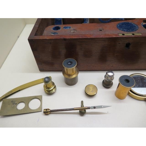 385 - A Victorian brass microscope by J Cooke York with mahogany box and assorted fittings