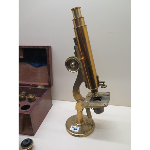 385 - A Victorian brass microscope by J Cooke York with mahogany box and assorted fittings