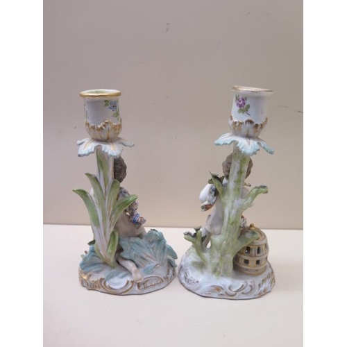 390 - A pair of figural porcelain candlesticks fisherman and bird catcher - Height 20cm - both with AR mar... 