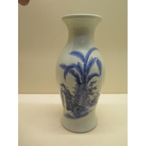 401 - A heavy blue and white oriental design vase - Height 21cm - generally good