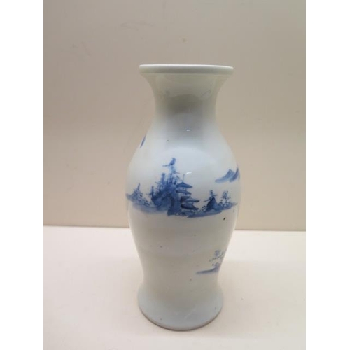 401 - A heavy blue and white oriental design vase - Height 21cm - generally good