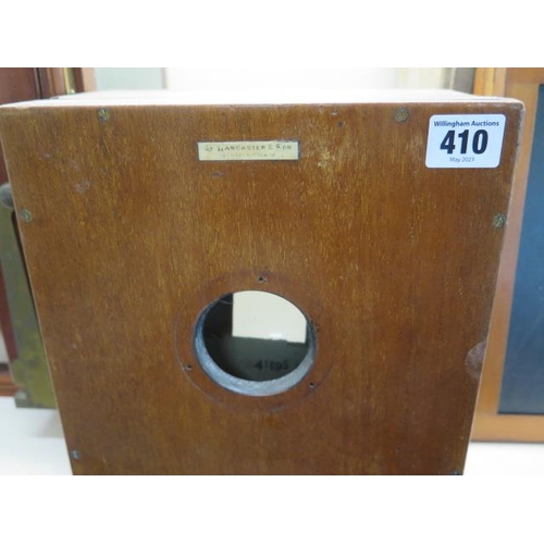 410 - A Lancaster mahogany full plate 25cm x 30cm bellows camera and sliding magnifier with three spare pl... 