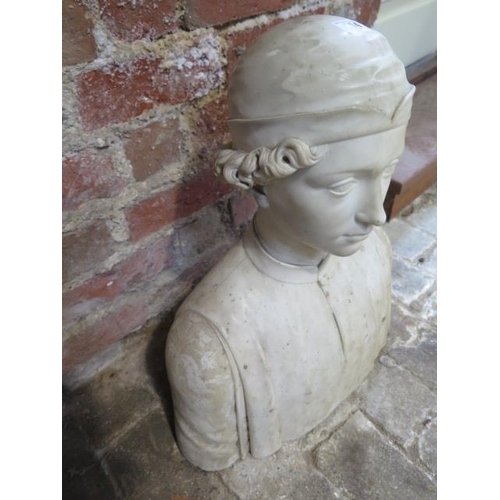 414 - A carved white marble bust of a young man wearing a cap and buttoned shirt with embroidered sleeves ... 