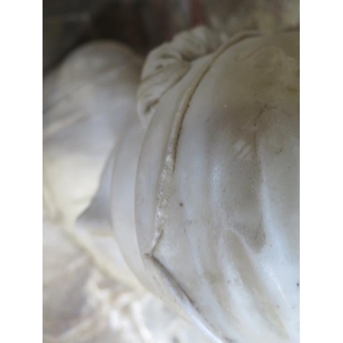 414 - A carved white marble bust of a young man wearing a cap and buttoned shirt with embroidered sleeves ... 