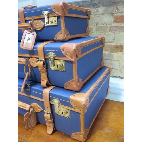 441 - A set of three blue canvas and tan leather graduating suitcases by Papworth Luggage with brass fitti... 