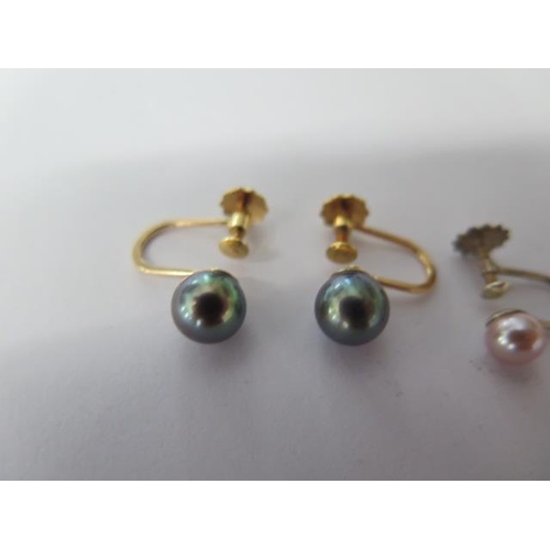 48 - A pair of 9ct screw back black pearl earrings and a pair of silver pearl screw back earrings - both ... 