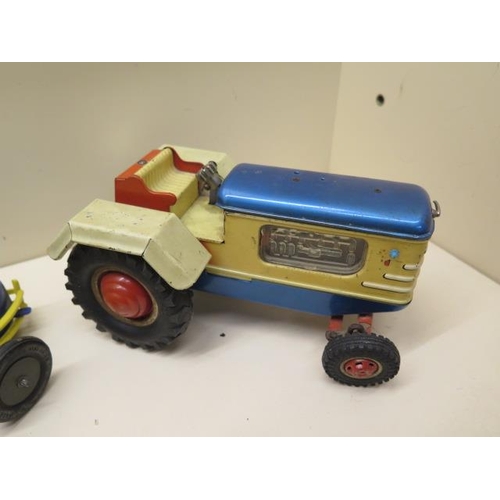 484 - A Gama tinplate battery operated tractor - Length 22cm - a plastic clockwork racing car, a tinplate ... 