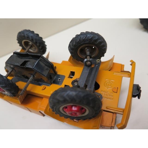 484 - A Gama tinplate battery operated tractor - Length 22cm - a plastic clockwork racing car, a tinplate ... 