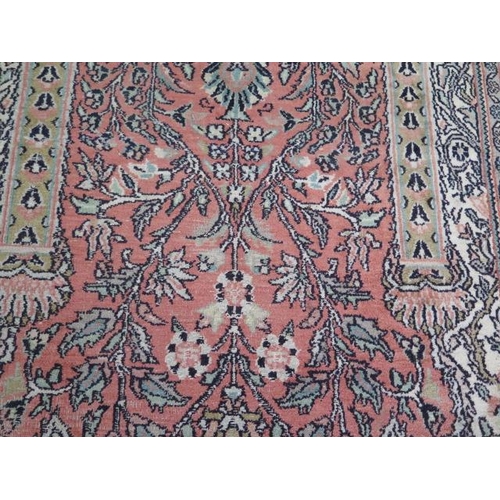 563 - A silk pile rug with a pink field and stylized boarder - 155cm x 95cm - reasonably good condition, s... 