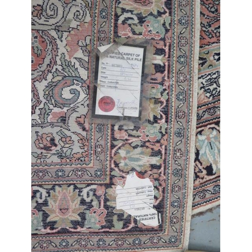 563 - A silk pile rug with a pink field and stylized boarder - 155cm x 95cm - reasonably good condition, s... 