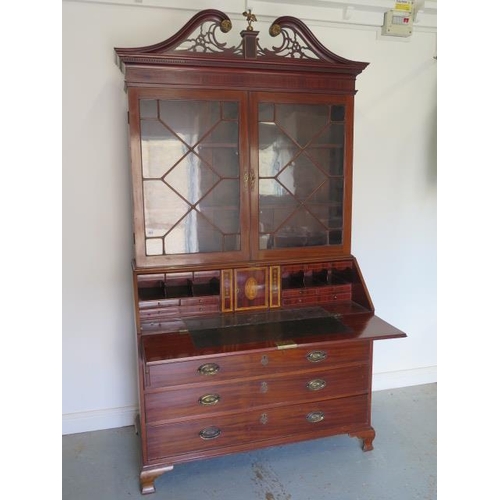 613 - An impressive Georgian mahogany bureau bookcase with a fretwork swan neck pediment, two astragal gla... 