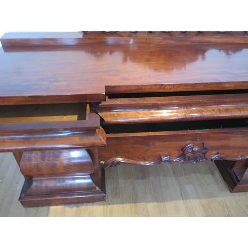 619 - An impressive early 19th century mahogany twin pedestal sideboard with two cupboards and three cushi... 