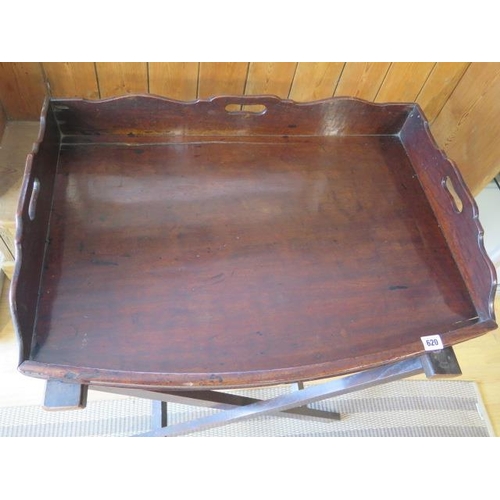 620 - A 19th century mahogany butlers tray on an associated stand - 73cm x 52cm