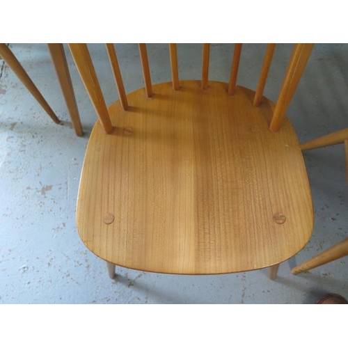 628 - An Ercol blonde elm dining table with four stick back chairs - Table 71cm tall x 152cm, Chairs 82cm ... 