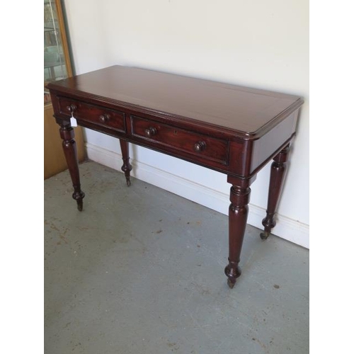 635 - A Victorian mahogany side table with two frieze drawers tapering and turned legs with brass caps and... 