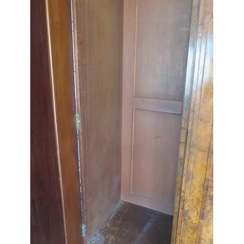 654 - A good quality mid Victorian burr walnut breakfront wardrobe with a central mirrored door flanked by... 