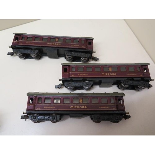 488 - Three early tinplate Marklin OO gauge coaches, two 0-4-4 locos (make unknown) and nine wood and meta... 