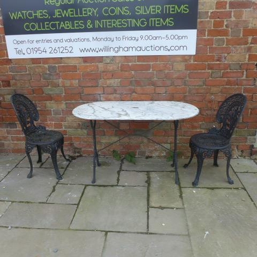 103 - A marble top garden table with a pair of ornate metal chairs, table 73cm tall x 120cm x 60cm