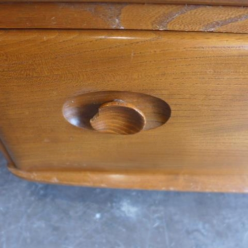 154 - An Ercol Golden Dawn elm sideboard with three cupboards above two drawers - good condition, some mar... 