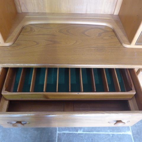 155 - An Ercol Golden Dawn blonde elm sideboard with glazed two door top over two cupboards and three draw... 