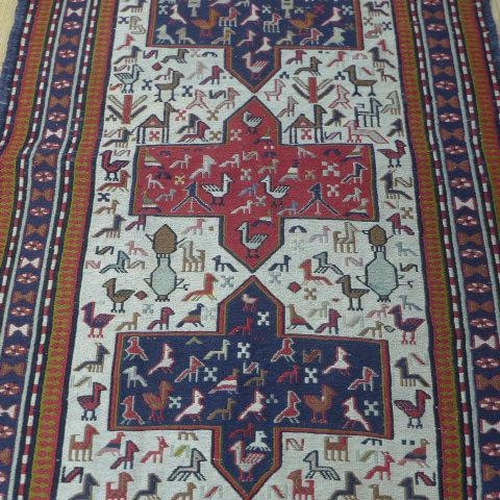 205 - A hand knotted woollen rug decorated with birds, 143cm x 104cm