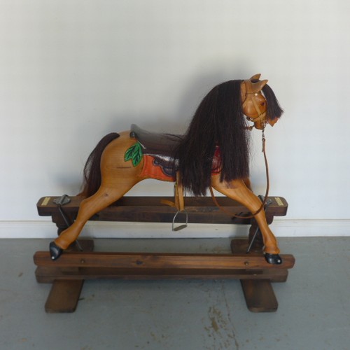 101 - A modern wooden Rocking Horse made by Engineering in wood, 109cm tall, with leather harness