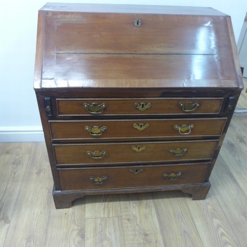 90 - A Georgian mahogany bureau with a well fitted interior over four drawers - Width 84cm x Height 96cm