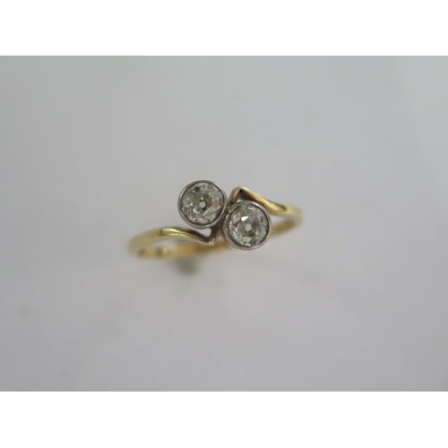 100 - An 18ct yellow gold two stone diamond crossover ring - each diamond approx 0.40ct - diamonds bright ... 