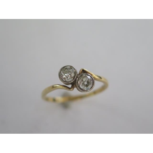 100 - An 18ct yellow gold two stone diamond crossover ring - each diamond approx 0.40ct - diamonds bright ... 