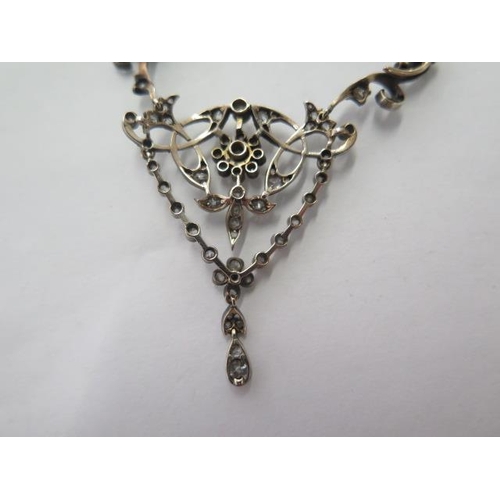 101 - A late Victorian diamond set negligee necklace with white trace link chain and scrolled supports to ... 