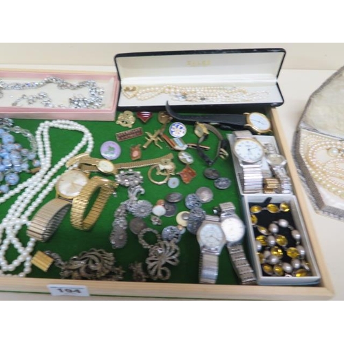 194 - A collection of assorted costume jewellery, watches, badges etc