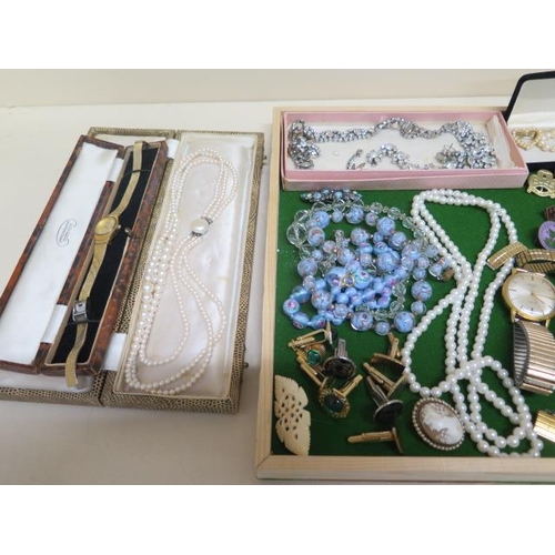 194 - A collection of assorted costume jewellery, watches, badges etc