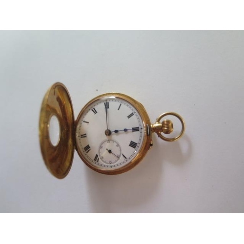 256 - An 18ct yellow gold half Hunter pocket watch with 35mm case, gold dust cover, approx 32 grams, good ... 