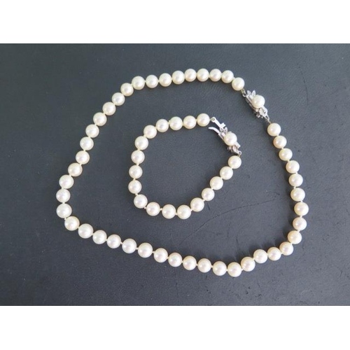 68 - A string of pearls, 40cm long, with an 18ct white gold catch and a matching bracelet 18cm long, pear... 