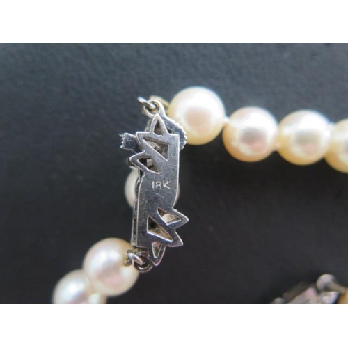 68 - A string of pearls, 40cm long, with an 18ct white gold catch and a matching bracelet 18cm long, pear... 