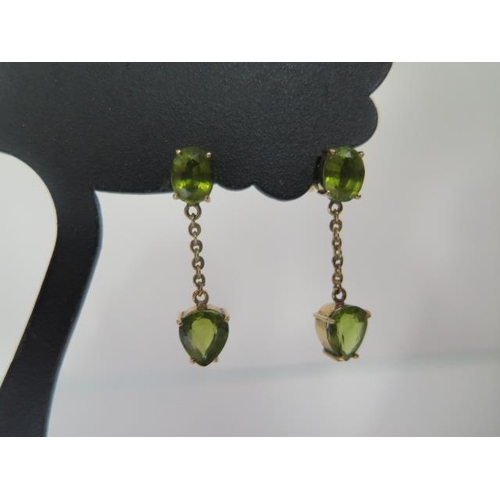 69 - A pair of 14ct yellow gold Peridot drop earrings 2.5cm long, approx 4 grams with receipts, condition... 