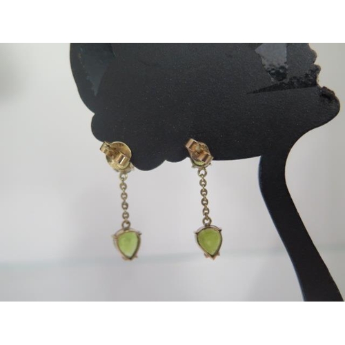 69 - A pair of 14ct yellow gold Peridot drop earrings 2.5cm long, approx 4 grams with receipts, condition... 