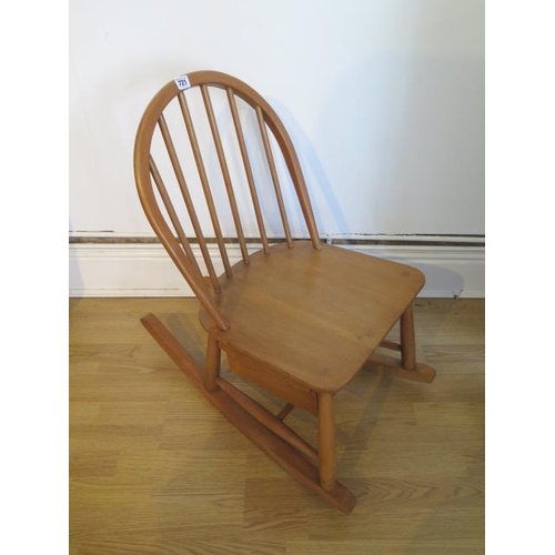 721 - An Ercol Blonde Elm child's rocking chair with sliding box - Height 72cm