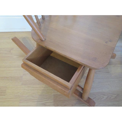 721 - An Ercol Blonde Elm child's rocking chair with sliding box - Height 72cm