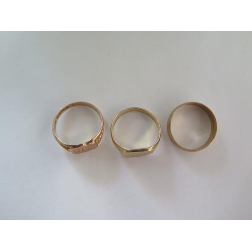 90 - Two 9ct yellow gold signet rings and a band ring, sizes Q and S, total approx 10.8 grams