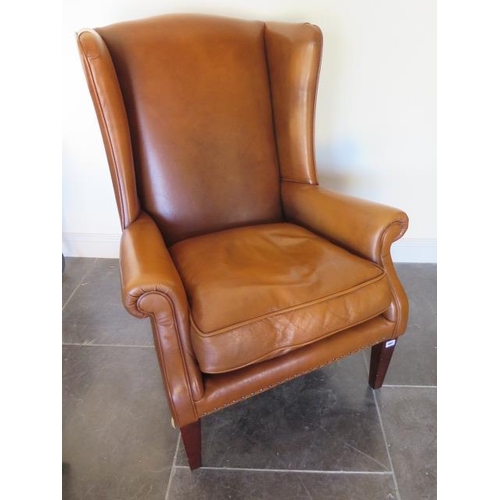 660 - An ex John Lewis tan leather Charles range wingback chair - Height 104cm x Width 78cm - in good cond... 