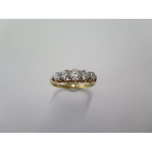 67 - An 18ct yellow gold five stone diamond ring size U - centre stone approx 0.25ct - stones bright and ... 