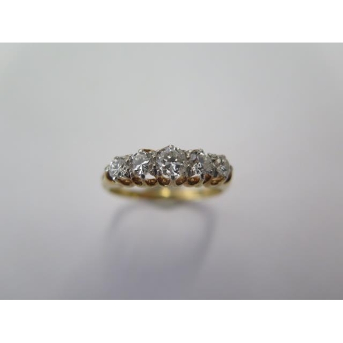 67 - An 18ct yellow gold five stone diamond ring size U - centre stone approx 0.25ct - stones bright and ... 