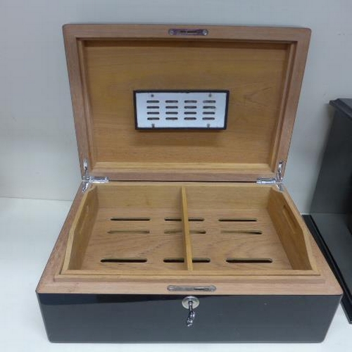 77 - Two ebonised cigar humidors - largest with five internal trays and a base drawer - some staining, no... 