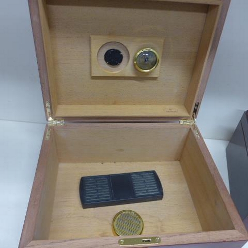 78 - Two cigar humidors one by Sikarlan with key - 15cm x 31cm x 25cm - both have some marks to exteriors... 