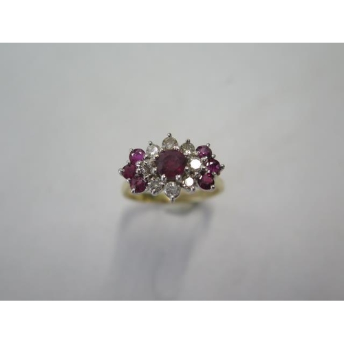 13 - A yellow gold diamond and ruby type cluster ring - surface tests to approx 18ct - with a central sto... 